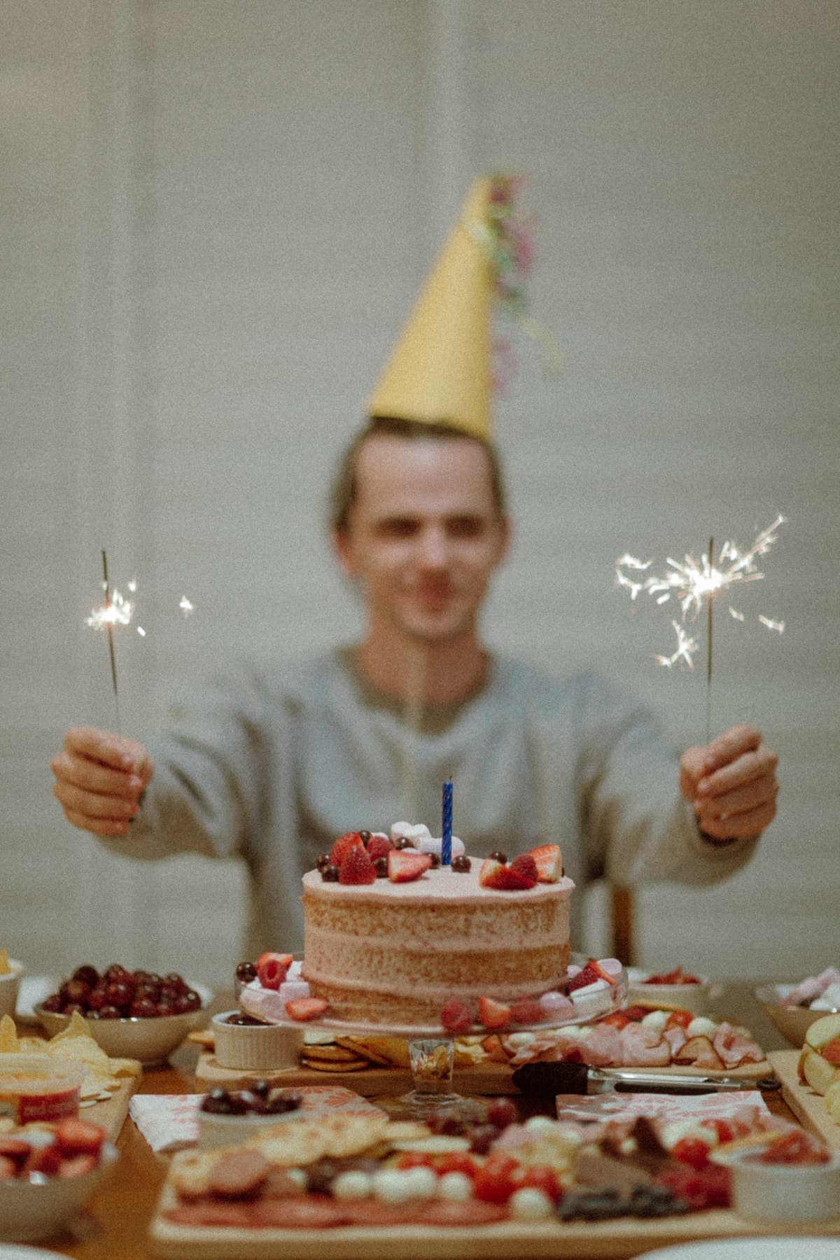 A warm birthday celebration with sparklers and a cake